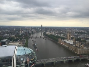 Bridges span the Thames on either side of the Parliament building very far below the London Eye