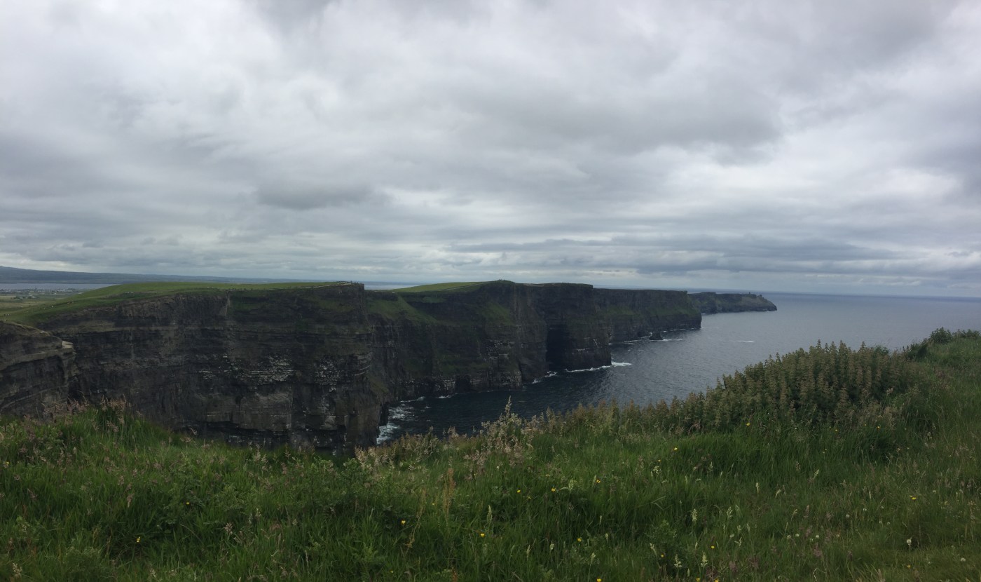 The Cliffs of Moher stretch into the distance over the ocean far below