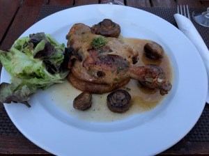 Duck confit with mushrooms, potatoes, and salad