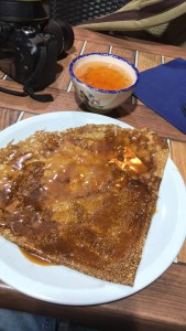 A salted butter and caramel crepe with a bowl of cider