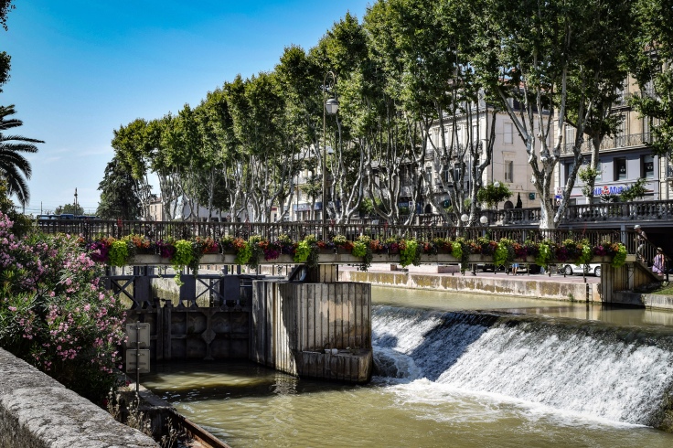 The flower lined passerelle over the lock system of the Canal de la Robine in Narbonne