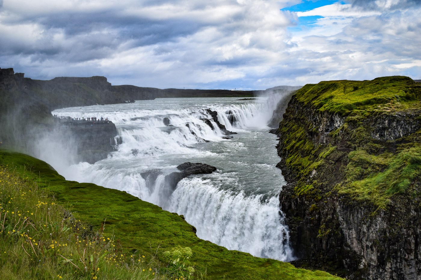 Gullfoss tumbling down multiple falls into a valley below surrounded by mist