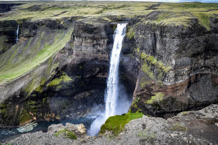 One of the falls in Haifoss tumbling down into the gorge surrounded by mist at the bottom