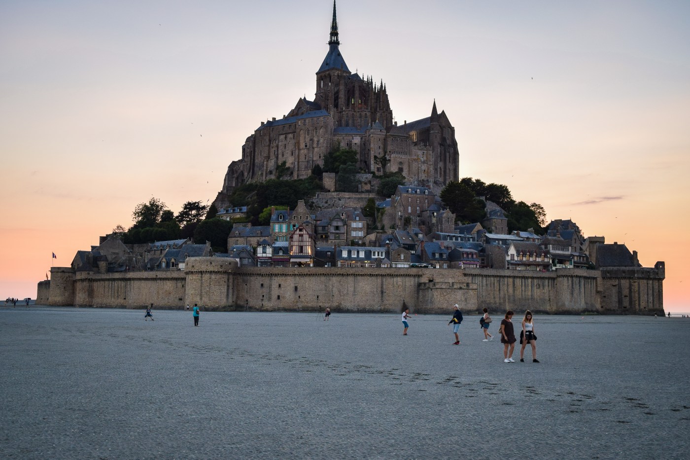 The island of Mont Saint Michel during low tide at sunset