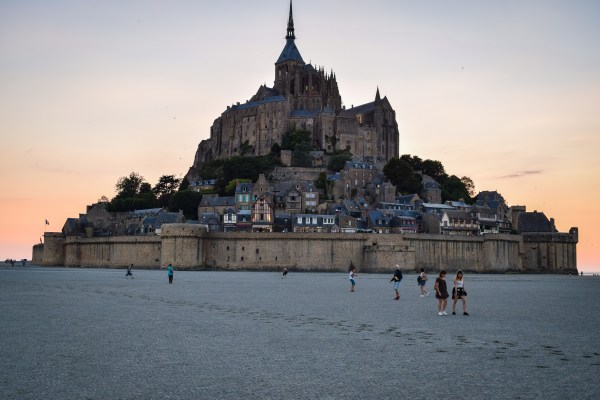The island of Mont Saint Michel during low tide at sunset