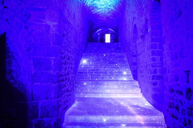 A stairway lit up to look like stars and galaxies inside Mont Saint Michel