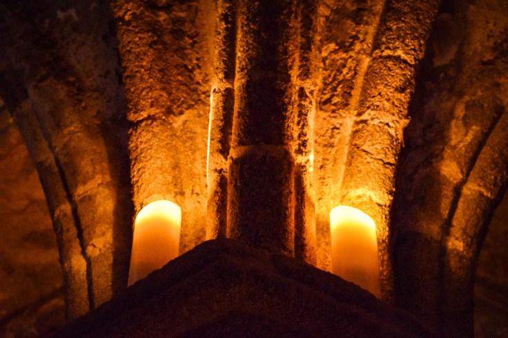 Candles lighting the vaulted ceilings during the nighttime tours of Mont Saint Michel