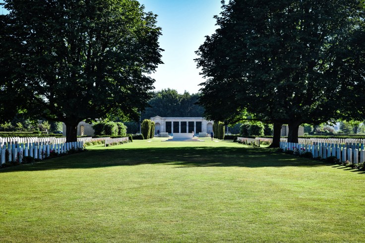 Rows of white tombstones in front of the British War Memorial in the Bayeux War Cemetery